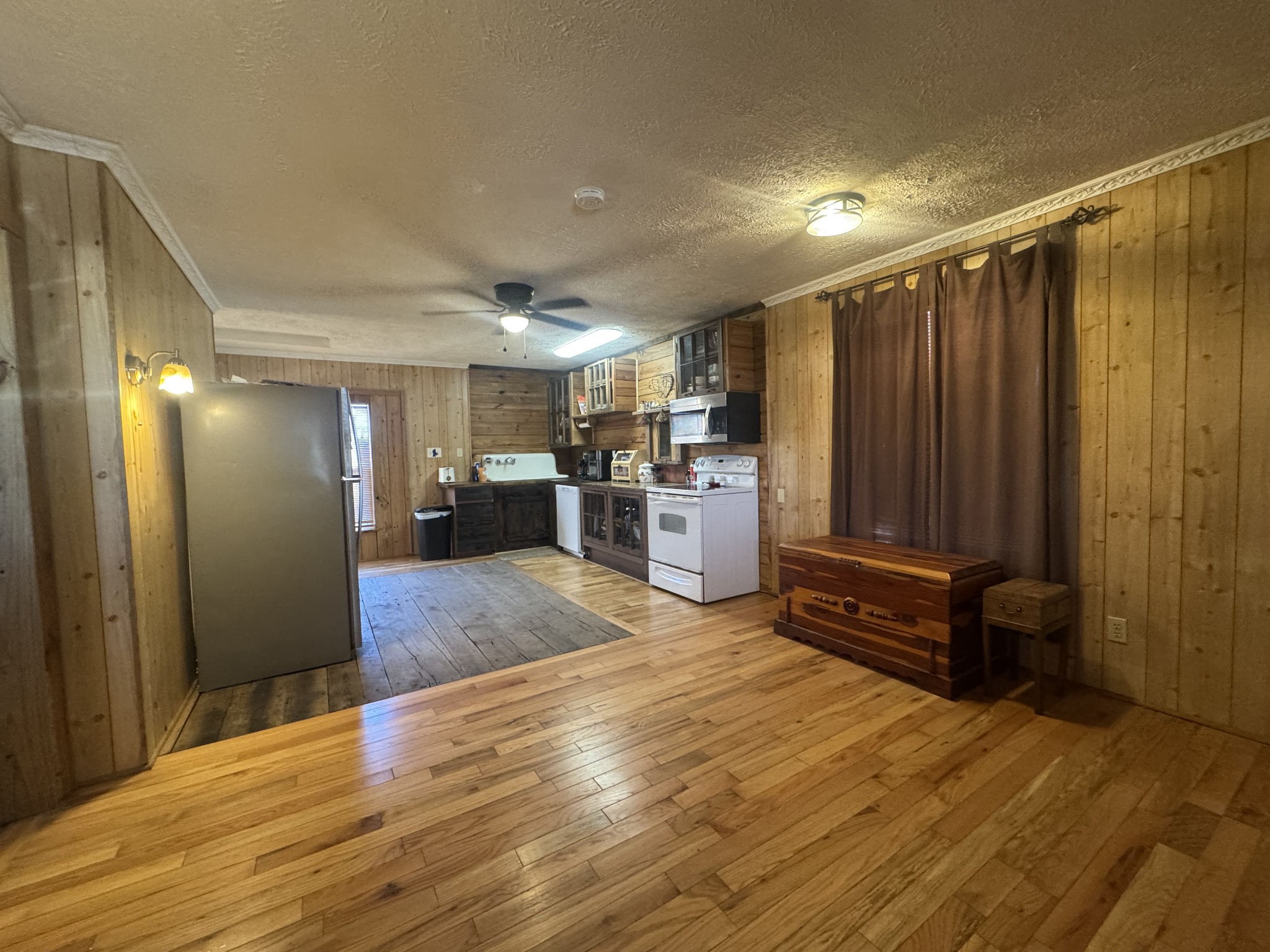 10795 Back Piney Road Bon Aqua, TN 37025 - Photo 23 of 64 a view of kitchen with refrigerator and wooden floor