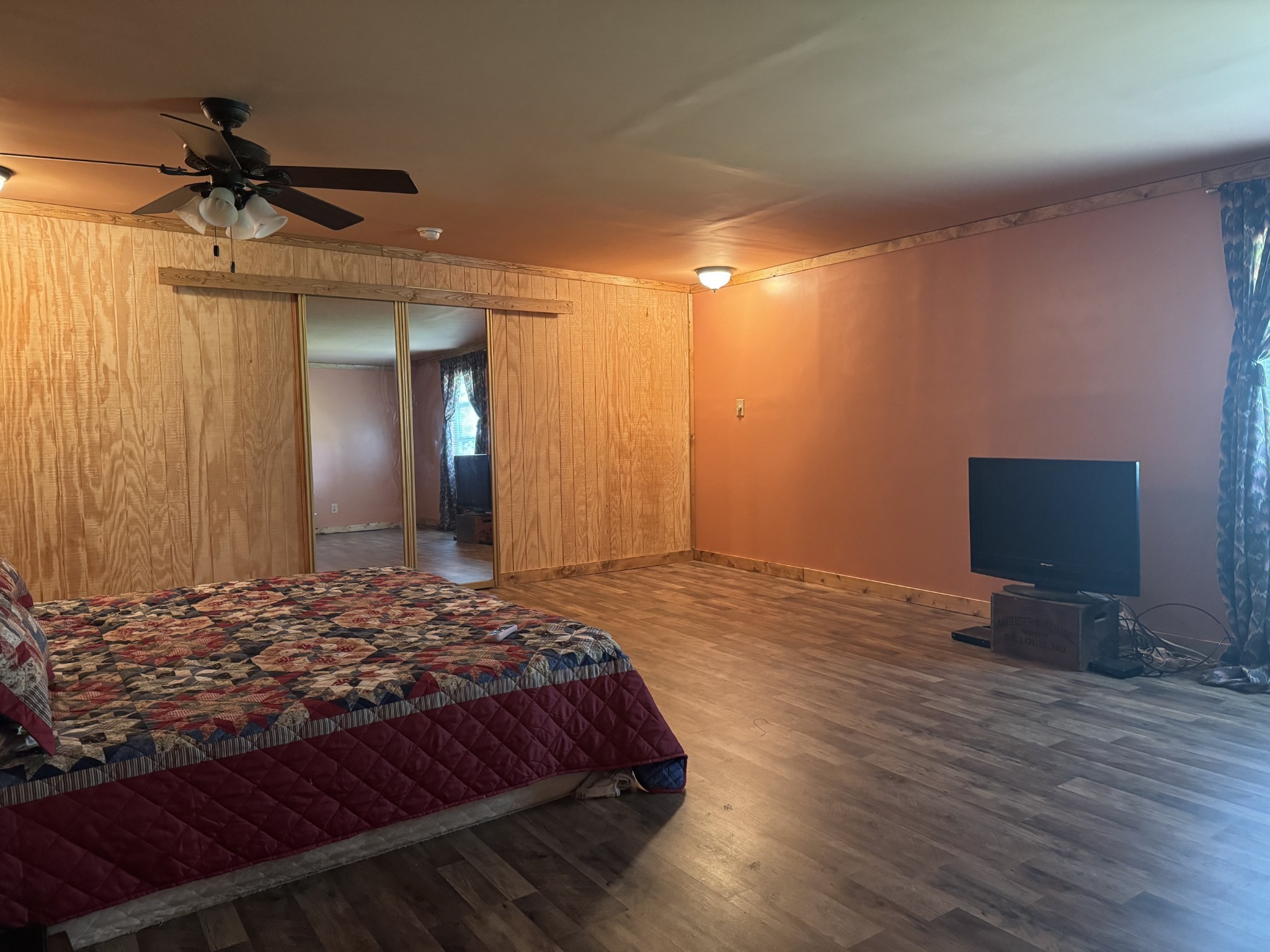 10795 Back Piney Road Bon Aqua, TN 37025 - Photo 29 of 64 a bedroom with a bed and a chandelier