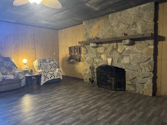 a view of empty room with wooden floor and fireplace