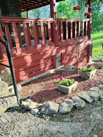 a view of small garden with wooden fence