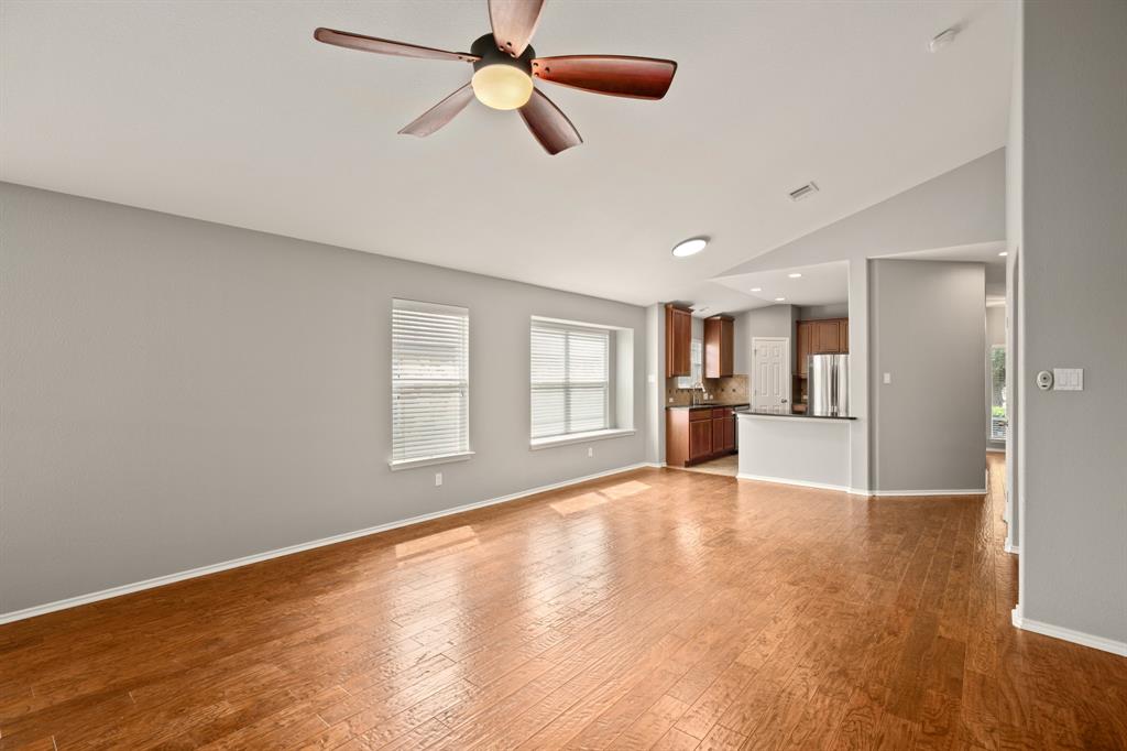 14012 Marathon Road Austin, TX 78717 - Photo 2 of 13 a view of an empty room with a window and wooden floor