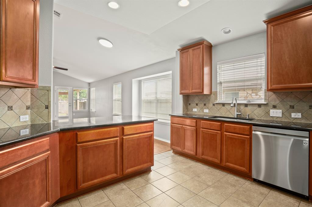 14012 Marathon Road Austin, TX 78717 - Photo 4 of 13 a large kitchen with stainless steel appliances granite countertop a sink and cabinets