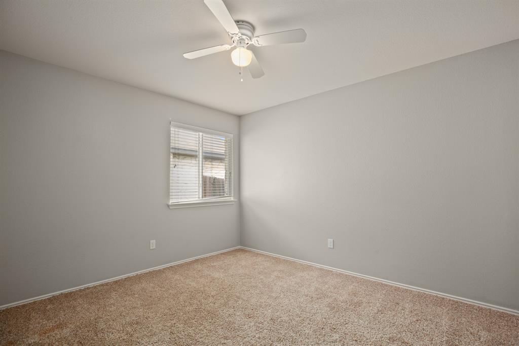 14012 Marathon Road Austin, TX 78717 - Photo 10 of 13 an empty room with a window and a ceiling fan
