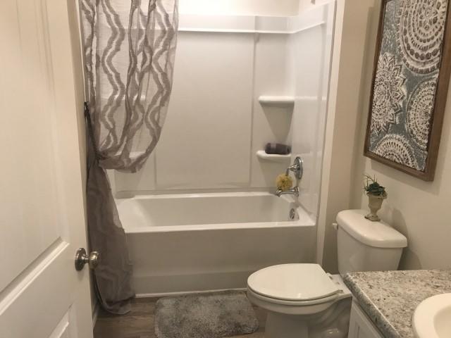 3582 Sugar Maple Lane Crestview, FL 32539 - Photo 12 of 20 a bathroom with a toilet and a bathtub
