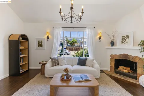 a living room with furniture a chandelier and a fireplace