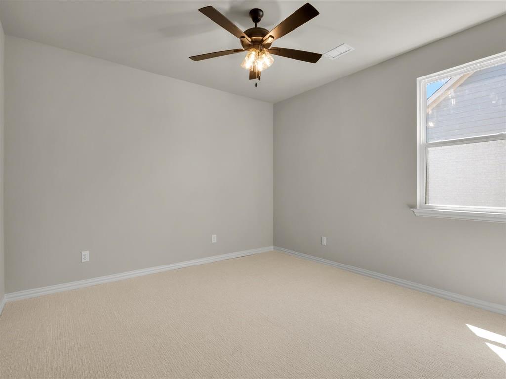 612 Jameson Springtown, TX 76082 - Photo 10 of 13 an empty room with a window and a fan