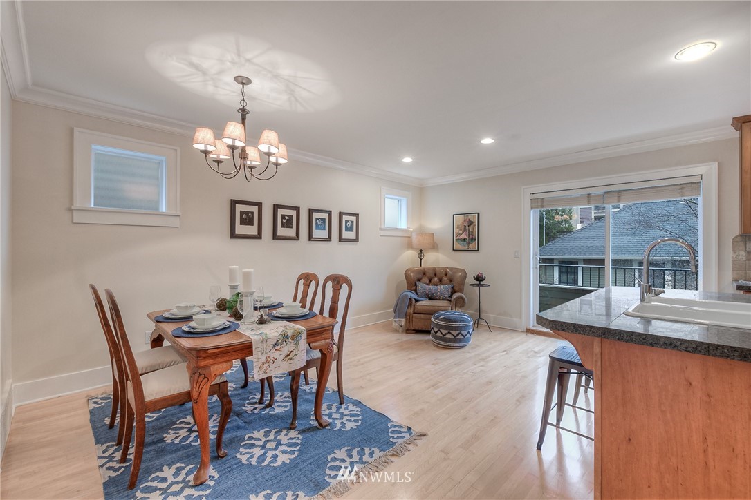1940 9th Avenue West Seattle, WA 98119 - Photo 11 of 25 a view of a dining room with furniture wooden floor and chandelier