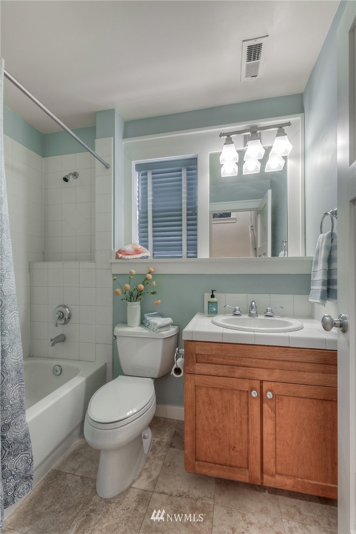 1940 9th Avenue West Seattle, WA 98119 - Photo 16 of 25 a bathroom with a sink a toilet and bathtub