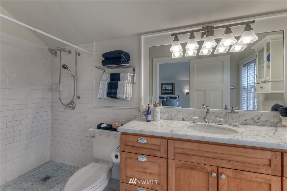 1940 9th Avenue West Seattle, WA 98119 - Photo 19 of 25 a bathroom with a sink double vanity and a mirror