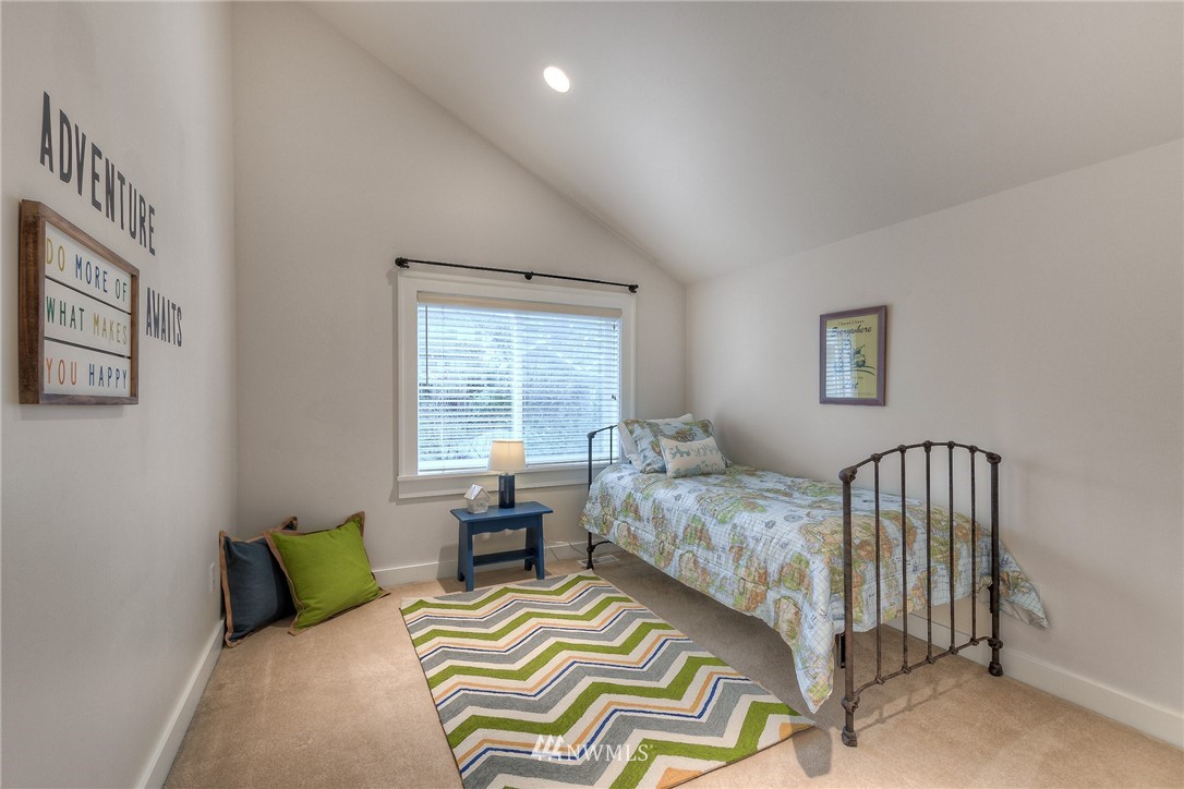1940 9th Avenue West Seattle, WA 98119 - Photo 20 of 25 a bedroom with a bed and a window