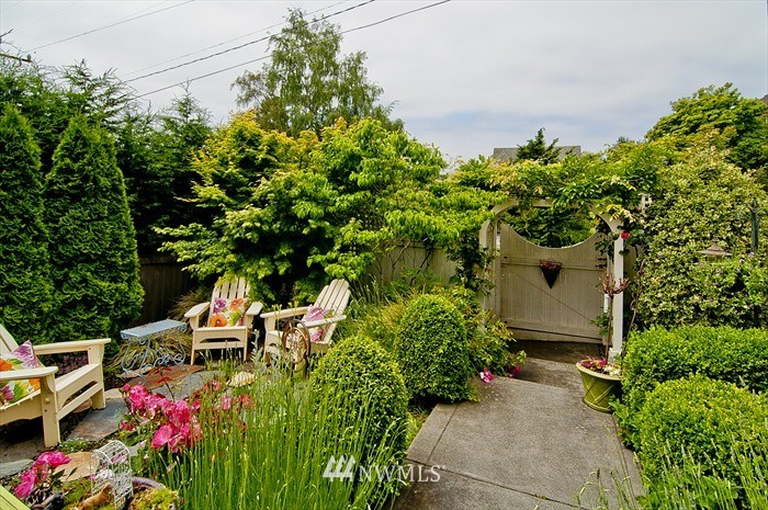 1940 9th Avenue West Seattle, WA 98119 - Photo 3 of 25 a view of a chair and table in a garden