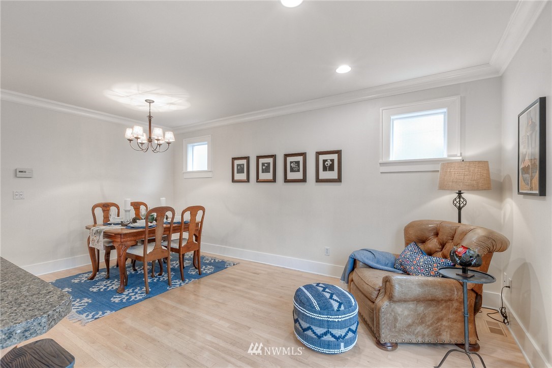 1940 9th Avenue West Seattle, WA 98119 - Photo 10 of 25 a dining room with furniture a chandelier and wooden floor