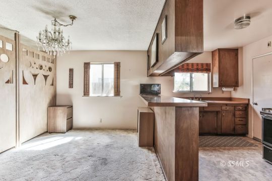 242 Peg Street Ridgecrest, CA 93555 - Photo 4 of 32 a kitchen with stainless steel appliances granite countertop a refrigerator and a sink