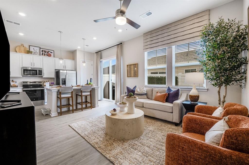 2507 Koji St Mount, Unit ELEVATE Mount Dora, FL 32757 - Photo 11 of 12 a living room with furniture and a large window