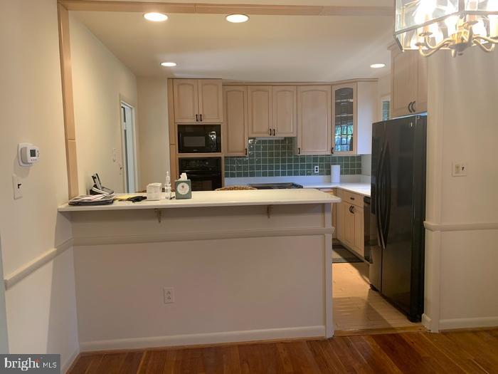 1902 Foxhall Road McLean, VA 22101 - Photo 3 of 15 a kitchen with kitchen island a sink appliances and cabinets