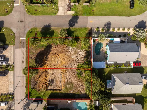 an aerial view of a houses with yard