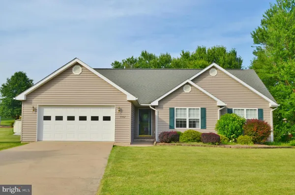 a view of a house with a yard and potted plants
