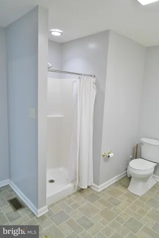 a bathroom with a shower and a toilet