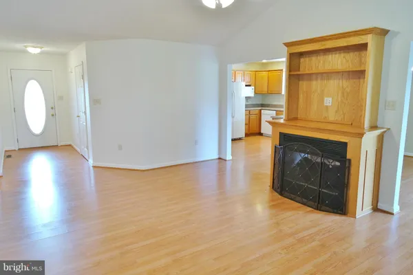a view of a livingroom with a fireplace and wooden floor