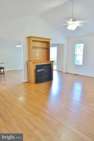 a view of a room with wooden floor and window