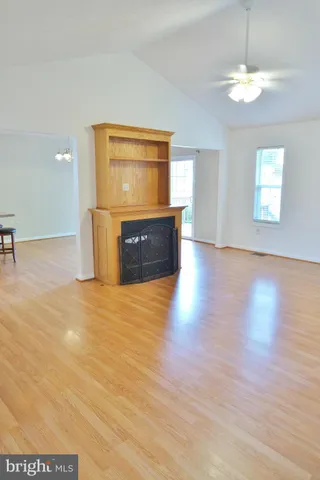 a view of a room with wooden floor and window