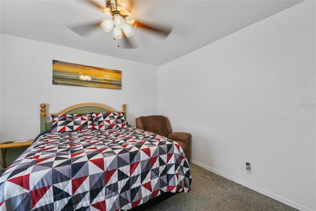 15 Yulee Arcadia, FL 34266 - Photo 15 of 33 a bedroom with a bed and a chandelier