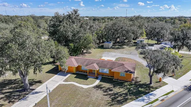 an aerial view of a house with a yard
