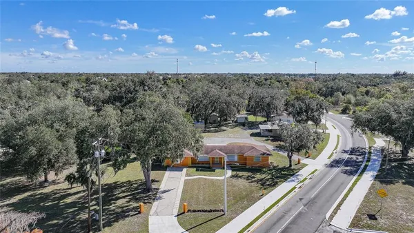 an aerial view of a house with a yard