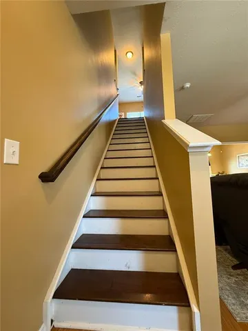 a spacious bedroom with a bed and a chandelier