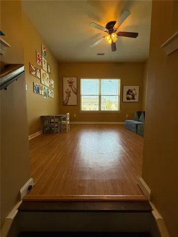 a view of a hallway with wooden shelves