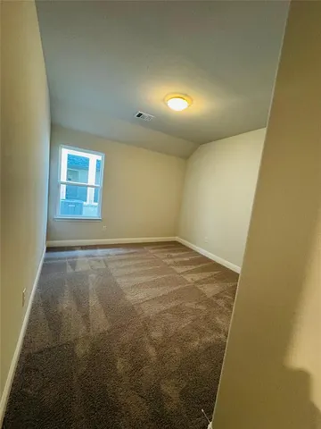 an empty room with a empty space and windows