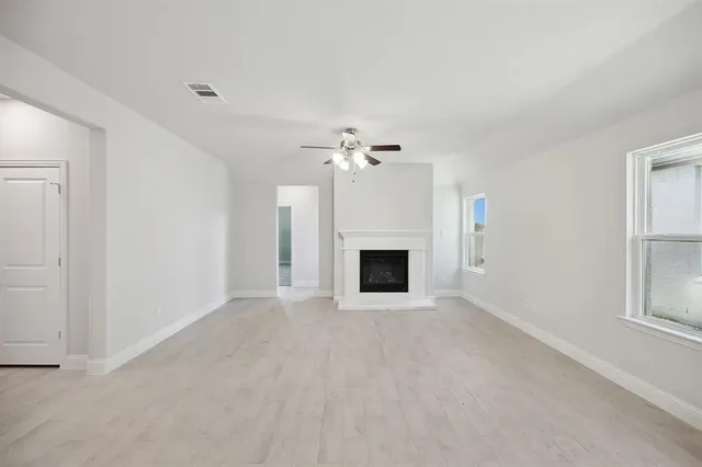 a view of an empty room with a fireplace