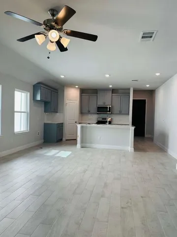 a view of a kitchen with a sink and a window