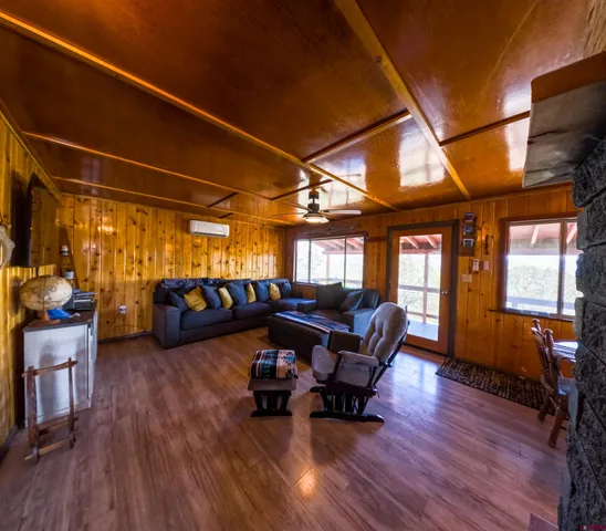 a living room with furniture and a chandelier