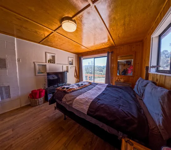 a bedroom with double bed and window