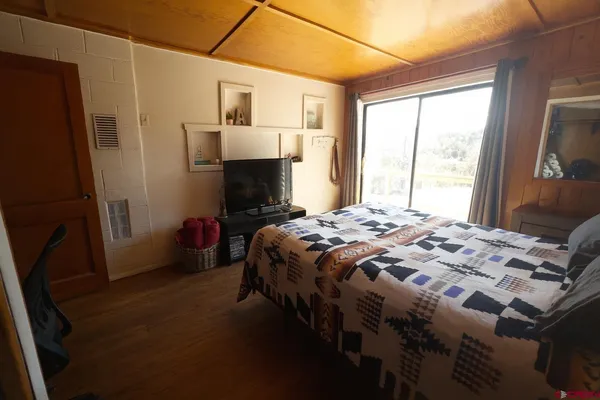 a room with a bed and wooden floor