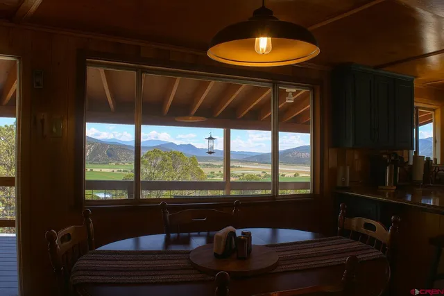 a living room with furniture a ceiling fan and a window