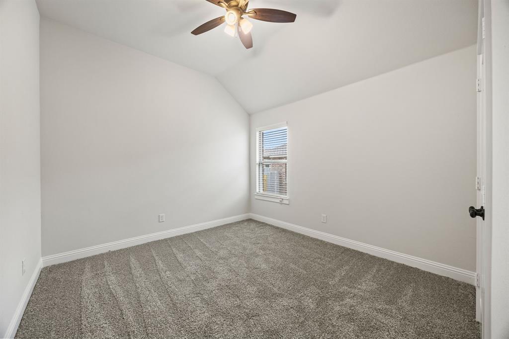 104 Maverick Trail Valley View, TX 76272 - Photo 23 of 30 an empty room with a ceiling fan and window