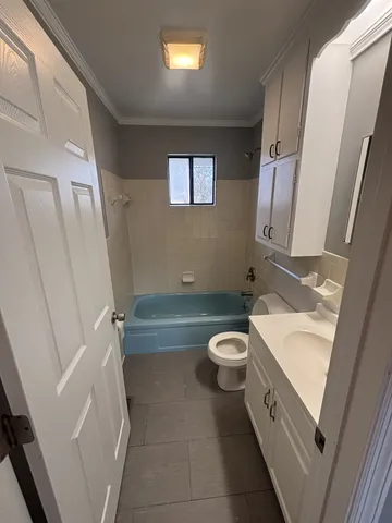 a bathroom with a sink a toilet and a tub