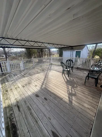 a view of a patio with wooden floor