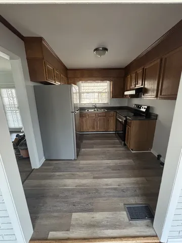 a kitchen with a refrigerator and window