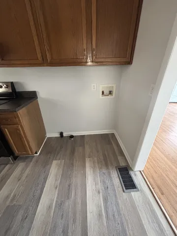 a view of a room with wooden floor and a window