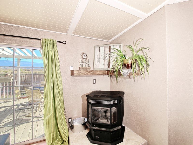 796 Siminoe Road Whitewater, CO 81527 - Photo 11 of 37 a living room with a fireplace and a floor to ceiling window