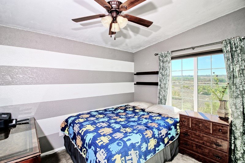 796 Siminoe Road Whitewater, CO 81527 - Photo 19 of 37 a bedroom with a bed and a window