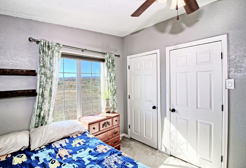 796 Siminoe Road Whitewater, CO 81527 - Photo 20 of 37 a bedroom with furniture and a window