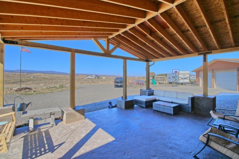 796 Siminoe Road Whitewater, CO 81527 - Photo 27 of 37 a bedroom with furniture and large windows