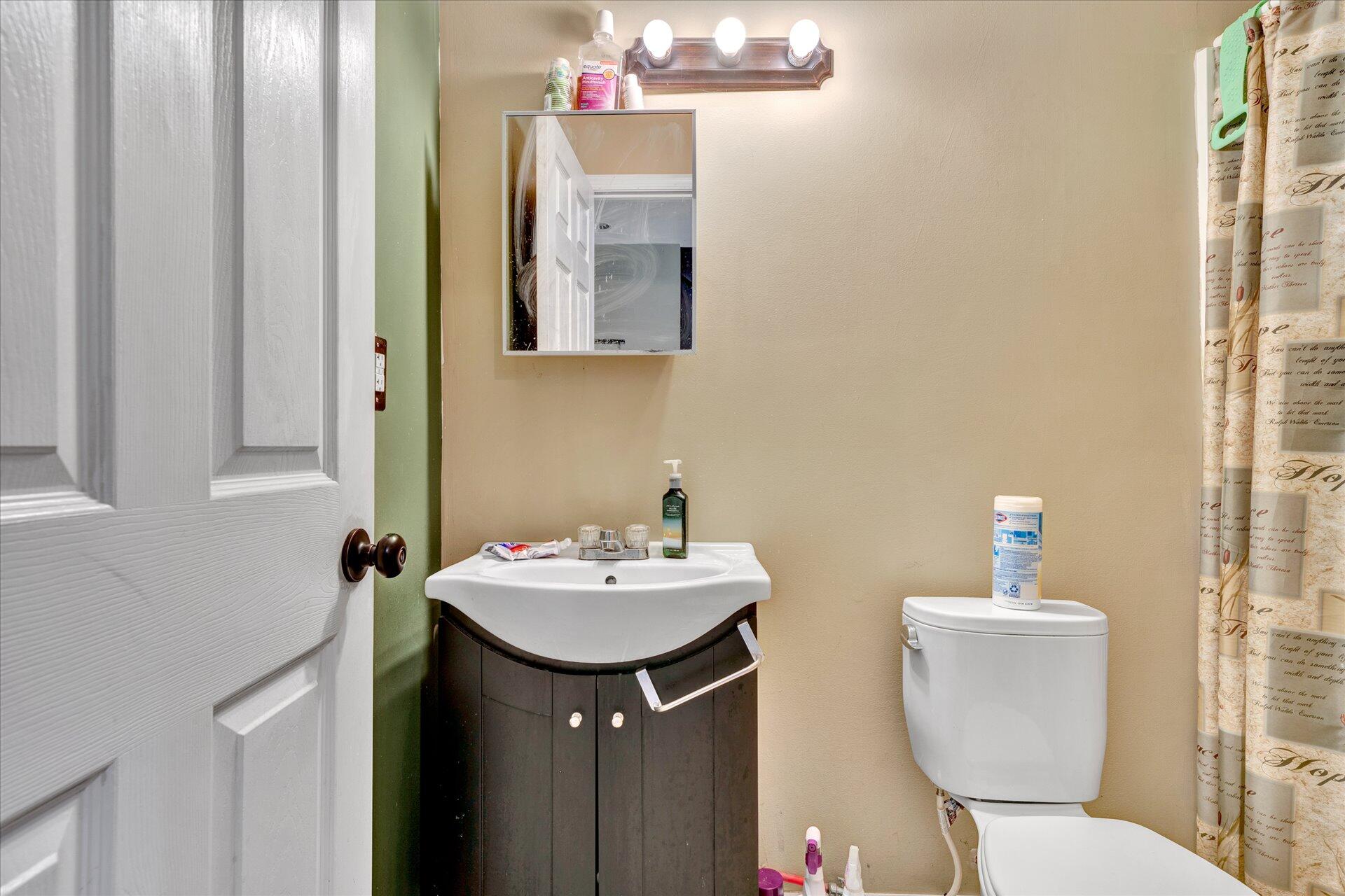 130 Highfield Road Rocky Mount, VA 24151 - Photo 20 of 23 a bathroom with a toilet sink and mirror