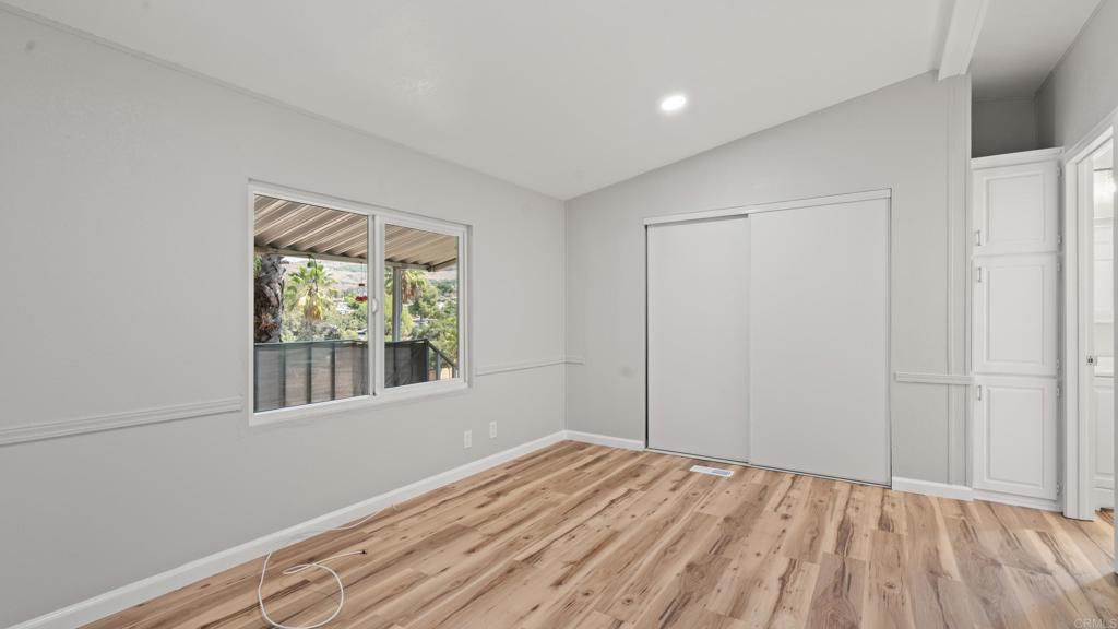 13490 Highway 8 Business, Unit 8 Lakeside, CA 92040 - Photo 17 of 29 a view of empty room with wooden floor and fan
