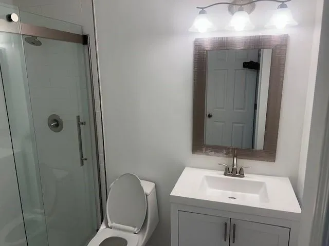 a bathroom with a sink toilet and shower