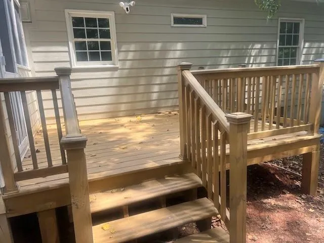 a porch with a bench next to a window